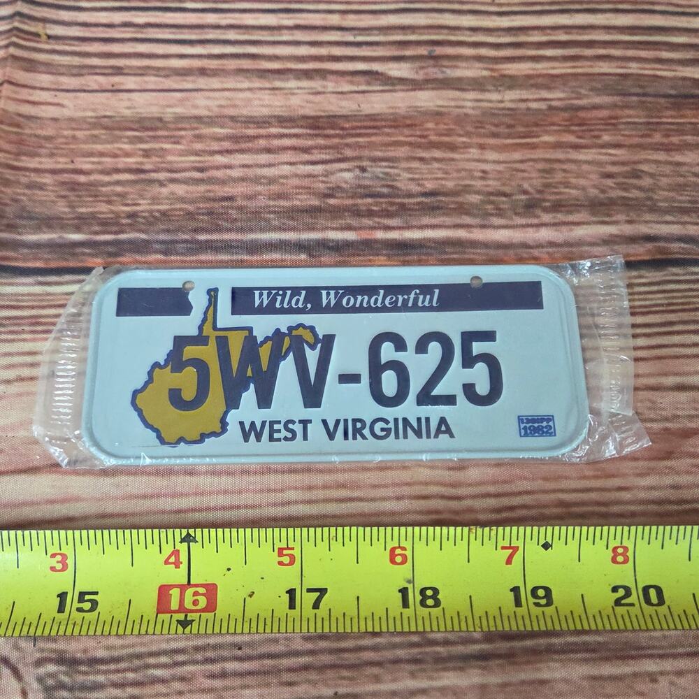 Vintage 1980s steel mini license plate West Virginia sealed white